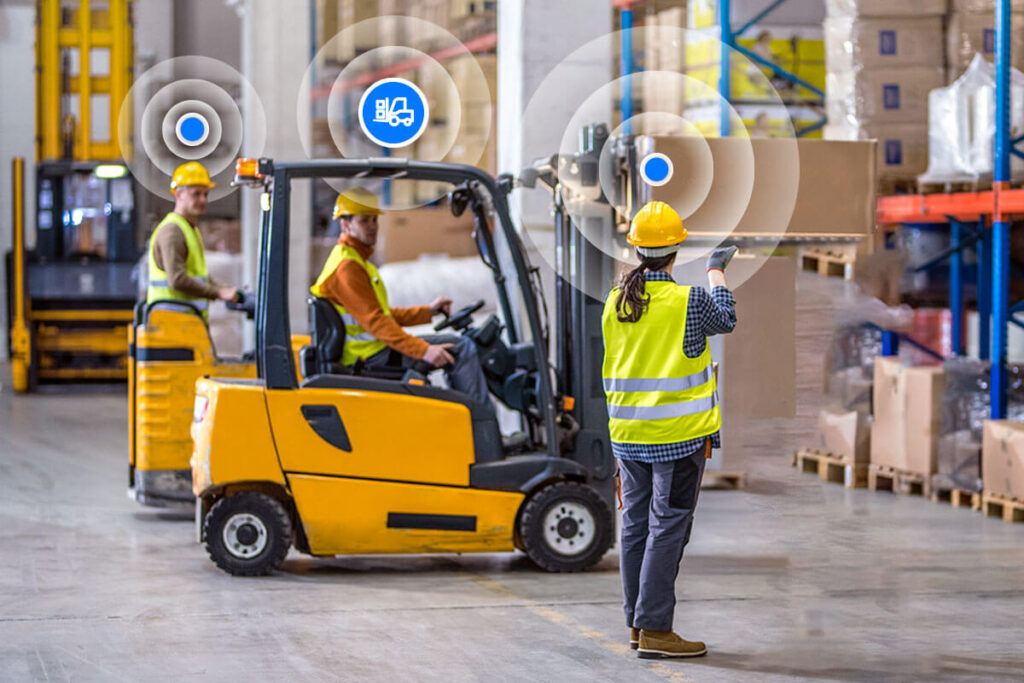 How RTLS Forklift Tracking Works and Why It Matters 3 Forklift approaching a pedestrian crossing zone in a warehouse with visible warning signage.
