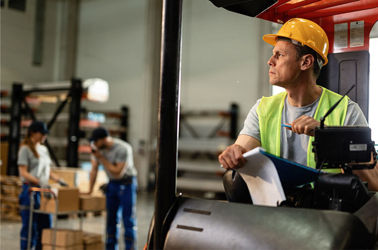 forklift collision warning Pensive forklift operator working in industrial warehouse