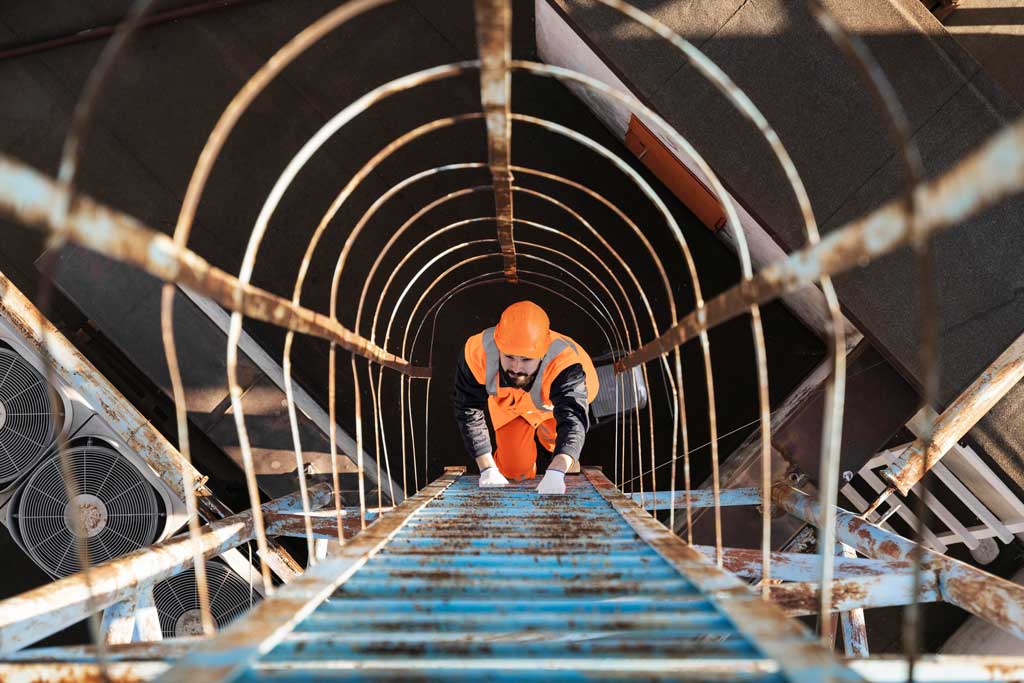 Worker climbing ladder