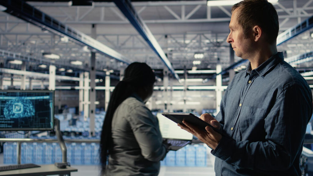 What Is BLE Indoor Positioning? How Bluetooth RTLS Works 1 A technician tracks assets via a BLE or UWB enabled tablet in a modern smart factory setting.
