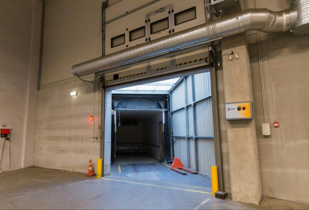 What Is RFID Asset Tracking? How It Works and Where It Fits 3 Alt text:Warehouse loading dock entrance with Litum RFID asset management control panel mounted on the wall for automated asset tracking at entry and exit points
