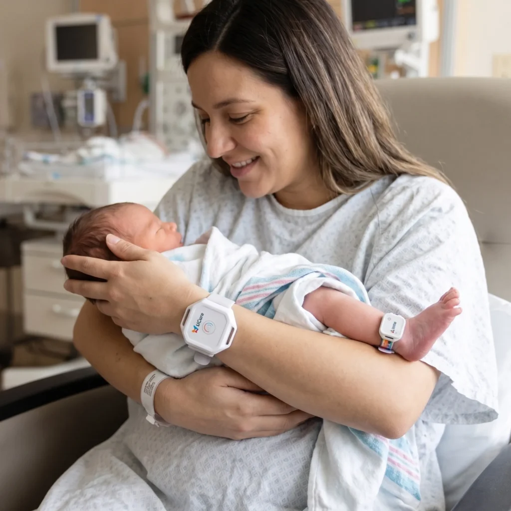 RTLS in Healthcare: Real-World Case Studies in Patient Safety, Staff Protection, and Asset Management 4 Mother holding newborn in hospital, both wearing Litum LiCure RTLS tags