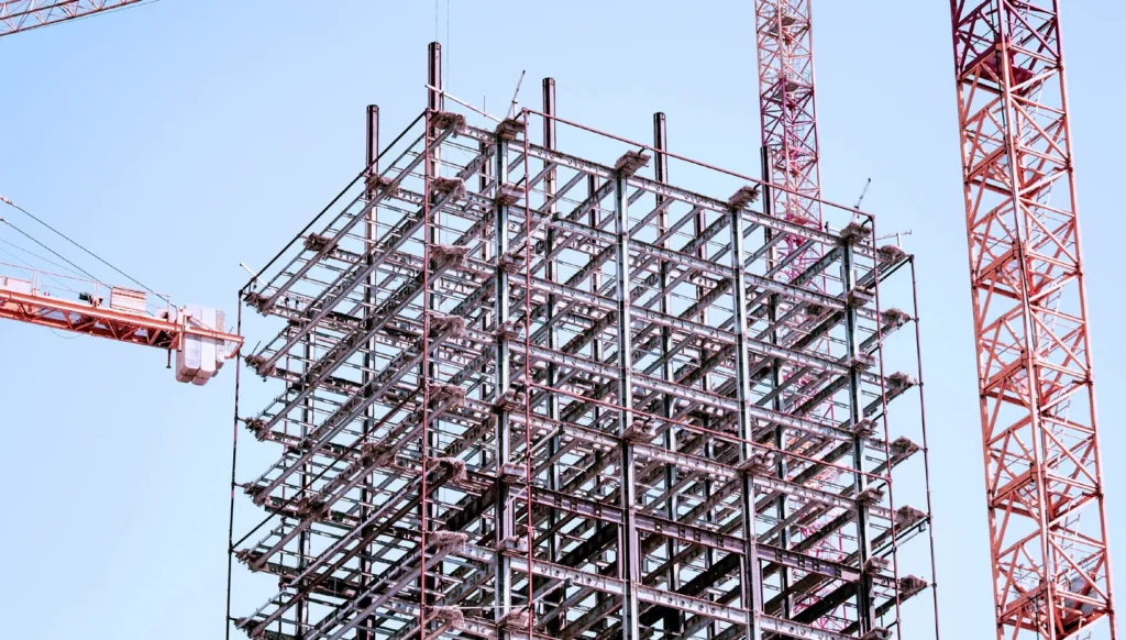 How RTLS Delivered $2.8M in Annual Savings for a Leading Global EPC Provider 1 Construction workers on a steel grid structure at a large fabrication yard protected by worker tracking RTLS