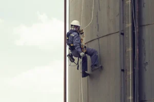 Industrial lone worker wearing safety equipment in a high-risk facility representing the need for real-time UWB RTLS tracking and lone worker safety monitoring systems