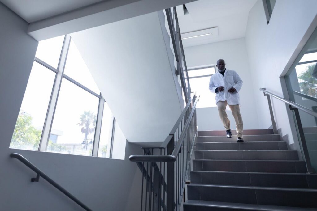 RTLS in Healthcare: Real-World Case Studies in Patient Safety, Staff Protection, and Asset Management 9 Healthcare worker moving quickly through a bright hospital corridor