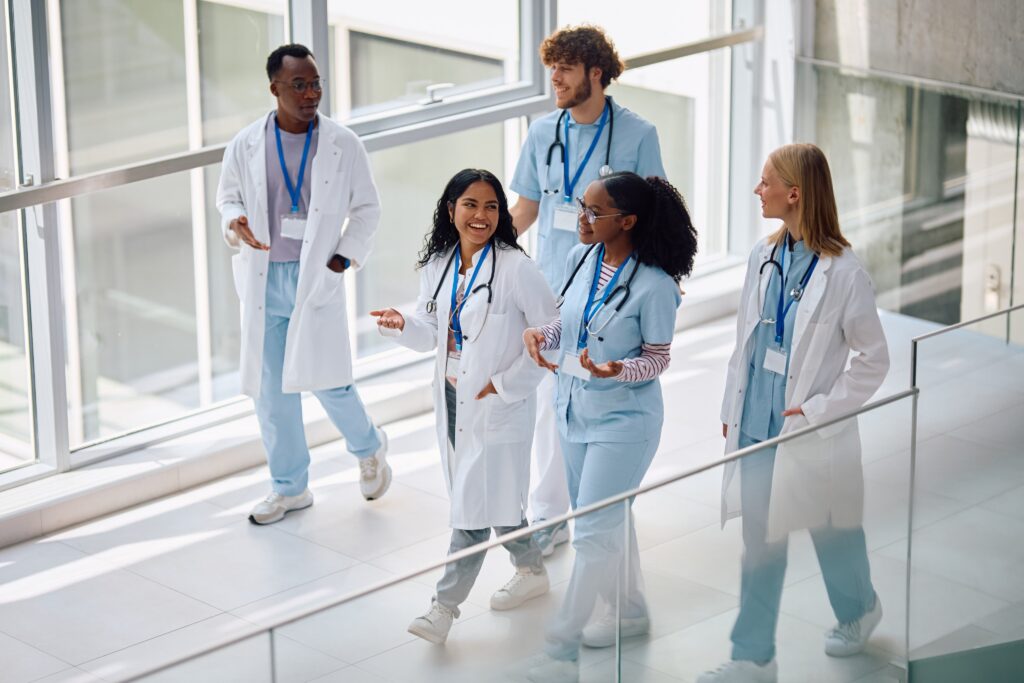 RTLS in Healthcare: Real-World Case Studies in Patient Safety, Staff Protection, and Asset Management 6 Diverse clinical team walking together in a hospital corridor