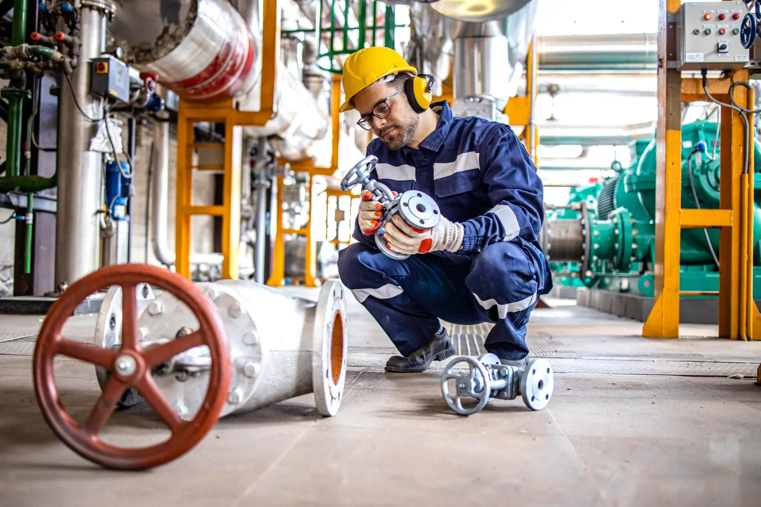 Home 79 Asset tracking in hazardous areas — maintenance engineer handling pipe valve in petrochemical plant requiring real-time equipment tracking across classified zones