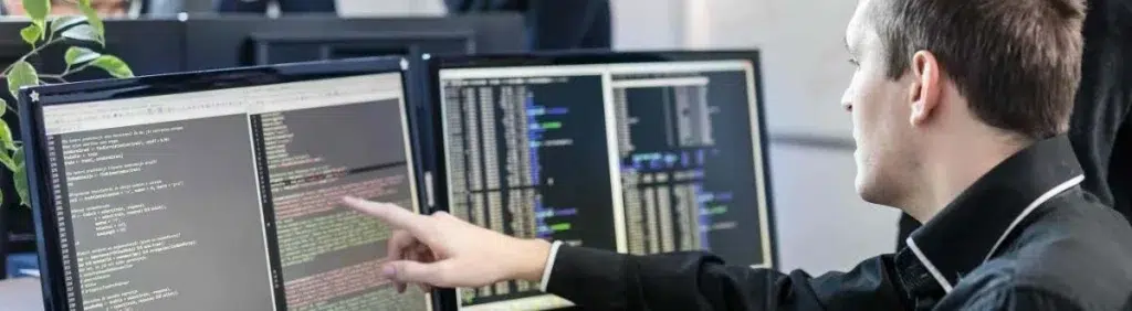 From Pilot to Plant-Wide: A Phased Rollout Framework for Industrial RTLS 2 IT team reviewing system integration and security data, reflecting the governance work required before scaling a phased rollout
