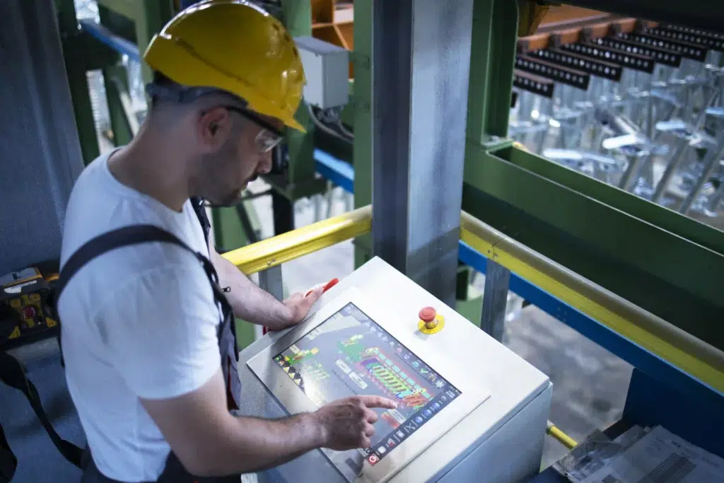 RTLS in Hazardous Areas: A Guide to ATEX Zone 1 and Zone 2 Tracking 2 Factory worker monitoring industrial machines and production remotely in a control room