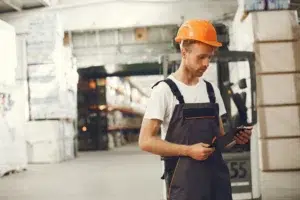 Operations manager reviewing RTLS vendor proposals on a tablet in a warehouse facility