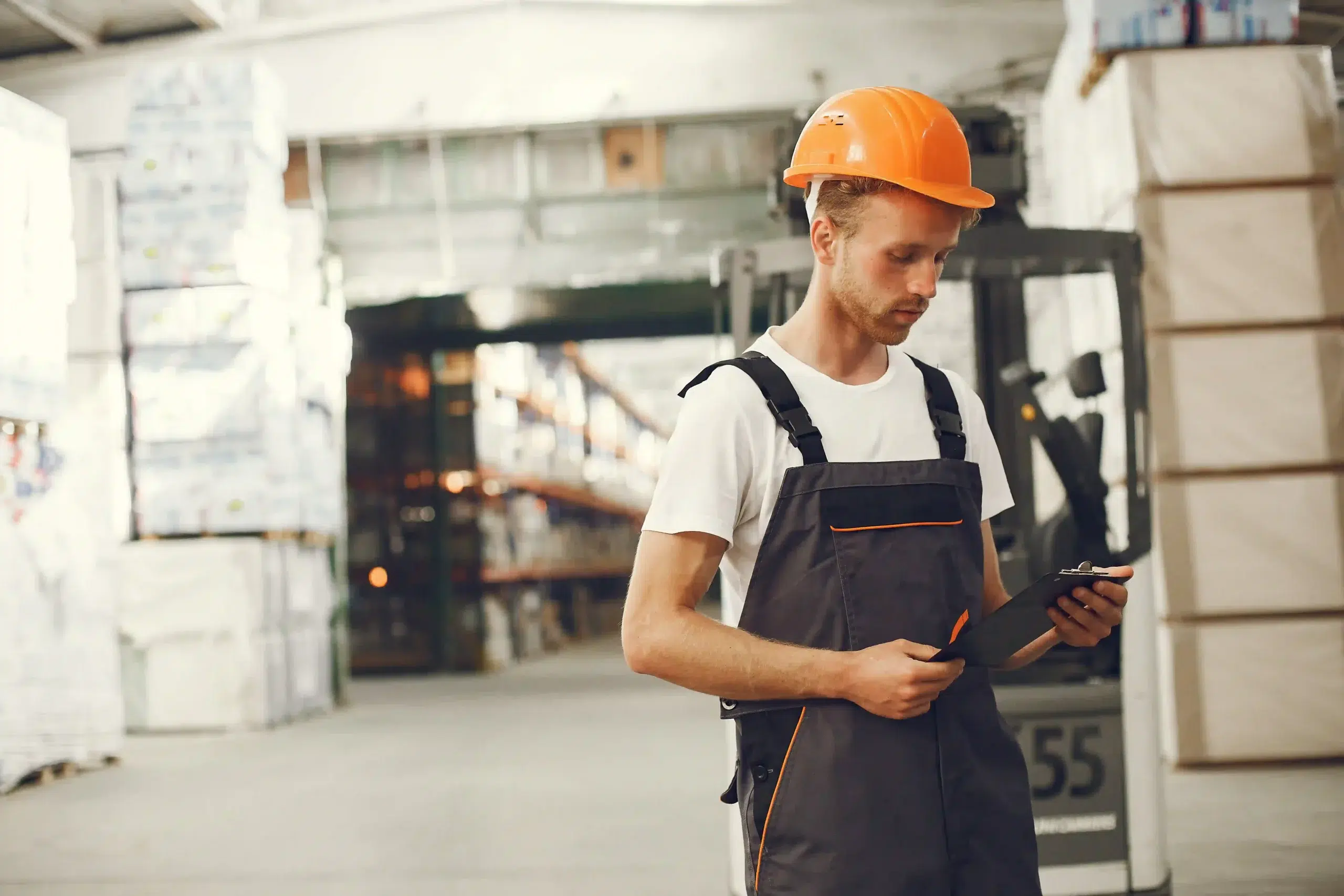Home 79 Operations manager reviewing RTLS vendor proposals on a tablet in a warehouse facility