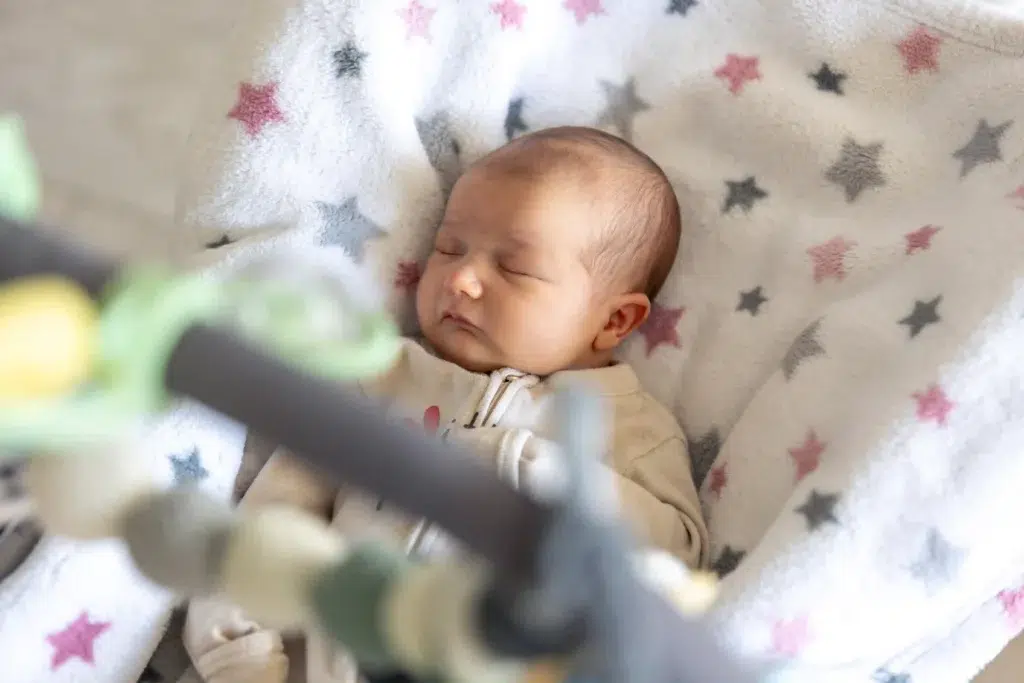 Healthcare Asset Tracking: How Hospitals Use RTLS to Find Equipment Faster 3 Newborn infant sleeping in a hospital bassinet under infant security monitoring