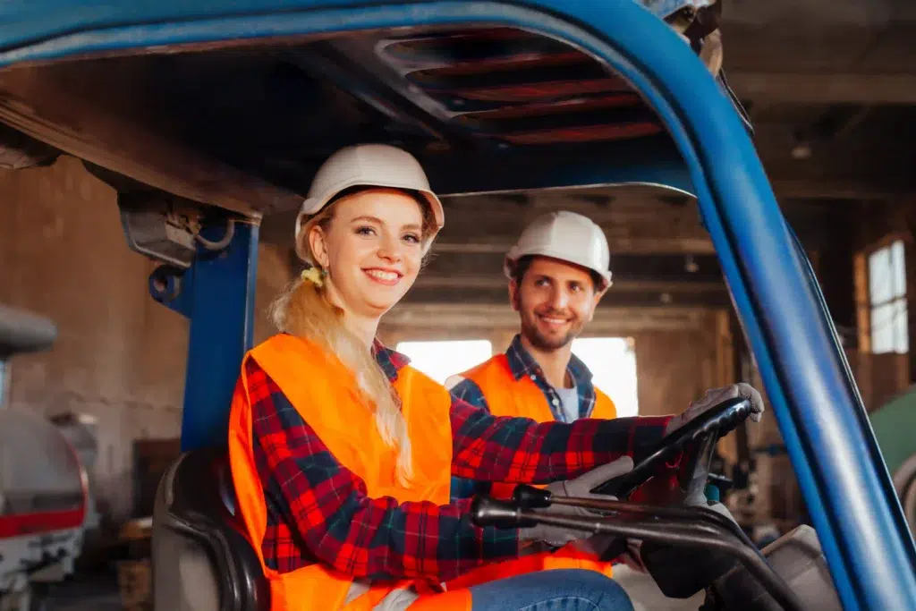 How to Choose an RTLS Vendor: The Industrial Buyer's Guide (2026) 23 Forklift operator and warehouse worker during an RTLS pilot deployment in a storage facility